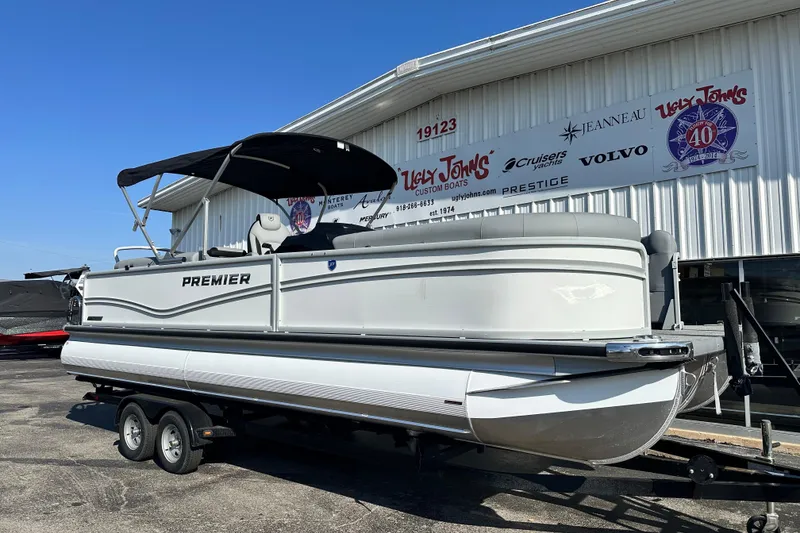 Slide: The Image of 2026 Premier 250 SunSation RF pontoon boat on trailer outside dealership. - 7