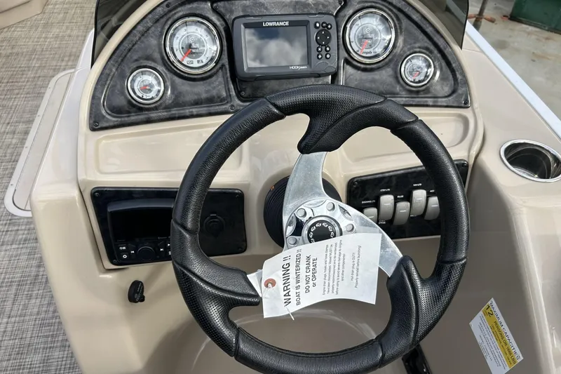 Slide: The Image of Steering console of 2022 SunCatcher Fusion 324SS with gauges and Lowrance display. - 11