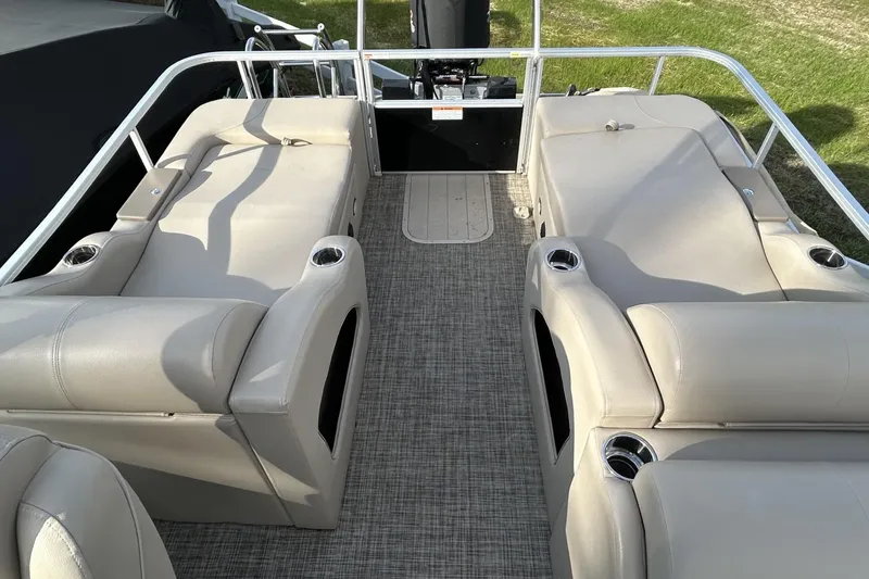 Slide: The Image of 2022 SunCatcher Fusion 324SS boat interior with beige seating and cup holders. - 4