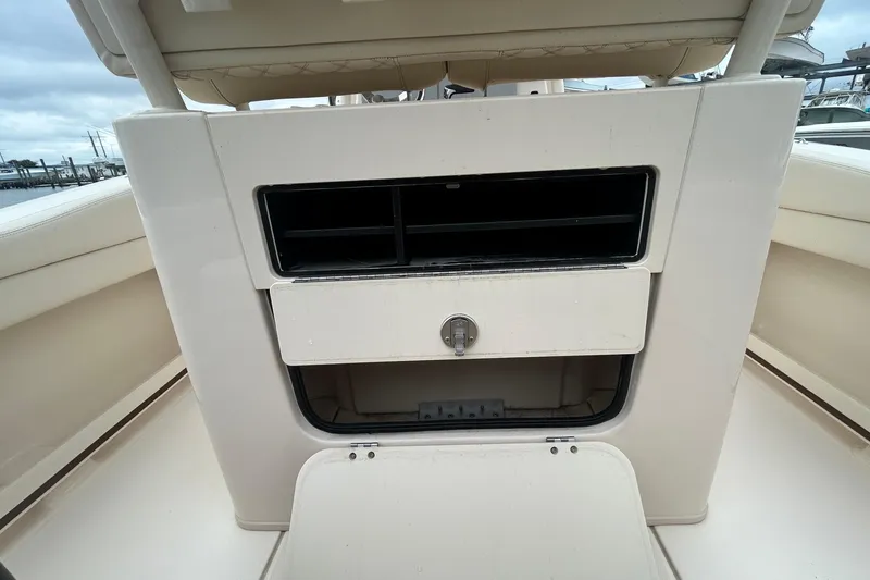 Slide: The Image of 2025 Grady-White Fisherman 236 boat storage compartment with lock, open on deck. - 10