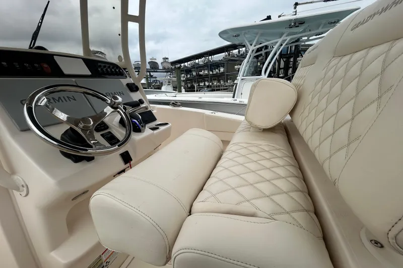 Slide: The Image of 2025 Grady-White Fisherman 236 boat interior with luxurious seating and modern steering console. - 11