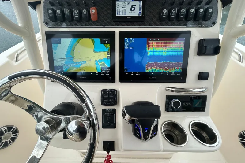 Slide: The Image of Control panel of 2025 Grady-White Fisherman 236 with navigation and sonar displays. - 13