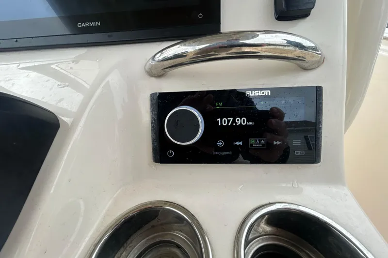 Slide: The Image of 2025 Grady-White Fisherman 236 dashboard with Fusion radio display at 107.90 MHz. - 14