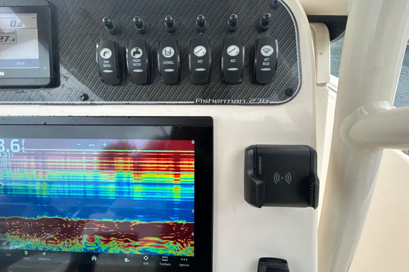 Slide: The Image of Control panel of 2025 Grady-White Fisherman 236 with sonar display and switches. - 16