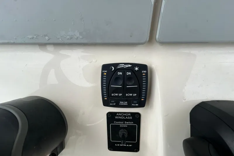 Slide: The Image of Control panel of 2025 Grady-White Fisherman 236 boat with trim tab and anchor windlass switches. - 17