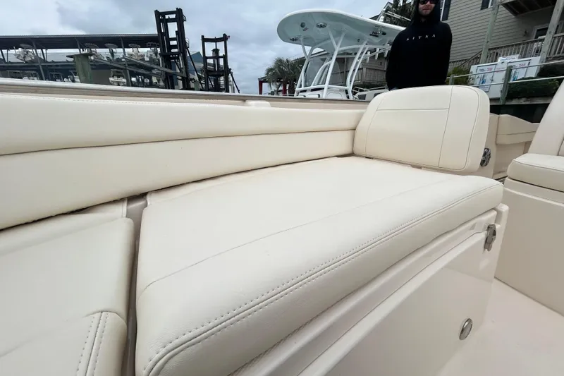 Slide: The Image of 2025 Grady-White Fisherman 236 boat with cream leather seating, dockside view. - 21