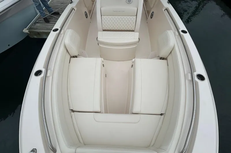 Slide: The Image of 2025 Grady-White Fisherman 236 boat interior with white cushioned seating. - 22