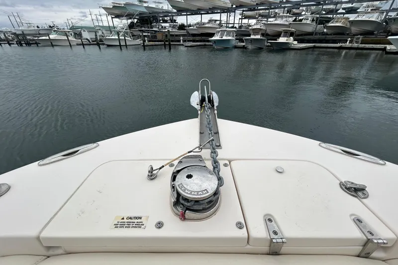 Slide: The Image of Bow view of 2025 Grady-White Fisherman 236 at marina with docked boats. - 24