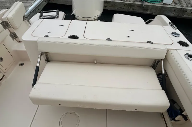 Slide: The Image of 2025 Grady-White Fisherman 236 boat interior with foldable seating and storage compartments. - 8