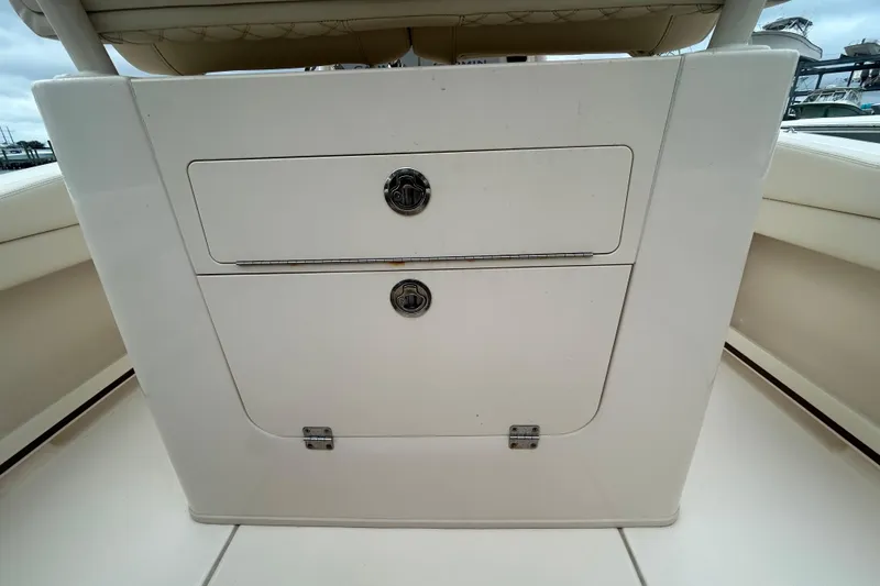 Slide: The Image of 2025 Grady-White Fisherman 236 boat storage compartment with secure latches. - 9