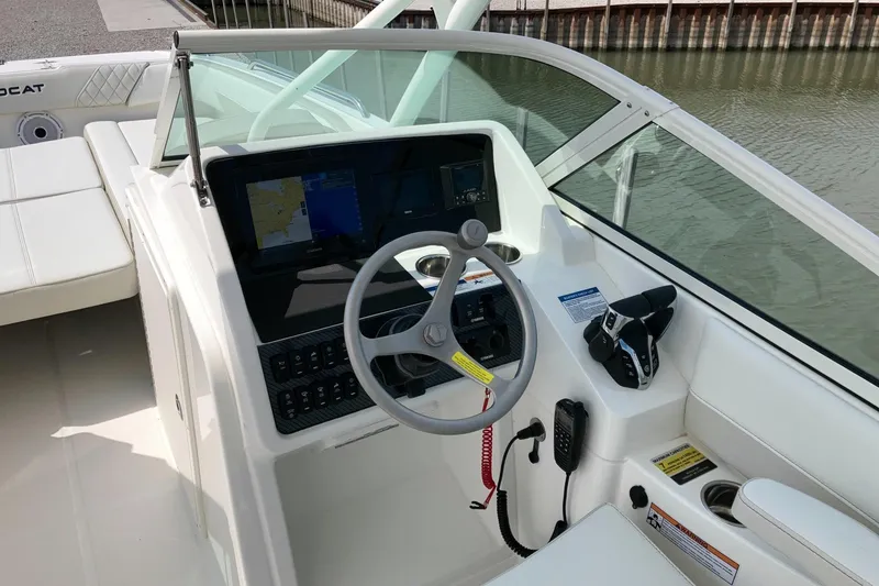 Slide: The Image of 2026 World Cat 230 SD boat cockpit with steering wheel and navigation system. - 6