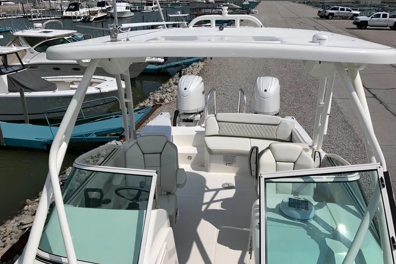 Slide: The Image of 2026 World Cat 230 SD boat docked, featuring dual engines and spacious seating. - 11