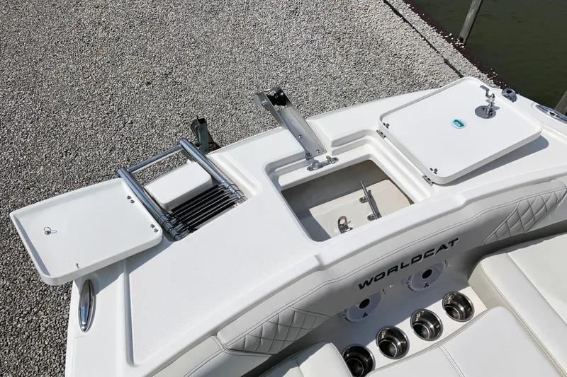 Slide: The Image of 2026 World Cat 230 SD boat deck with storage compartments and ladder. - 10