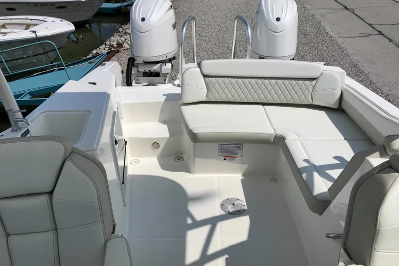 Slide: The Image of 2026 World Cat 230 SD boat interior with white seating and dual engines. - 12