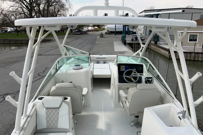 Slide: The Image of 2026 World Cat 230 SD boat interior with helm, seating, and modern controls at dock. - 5