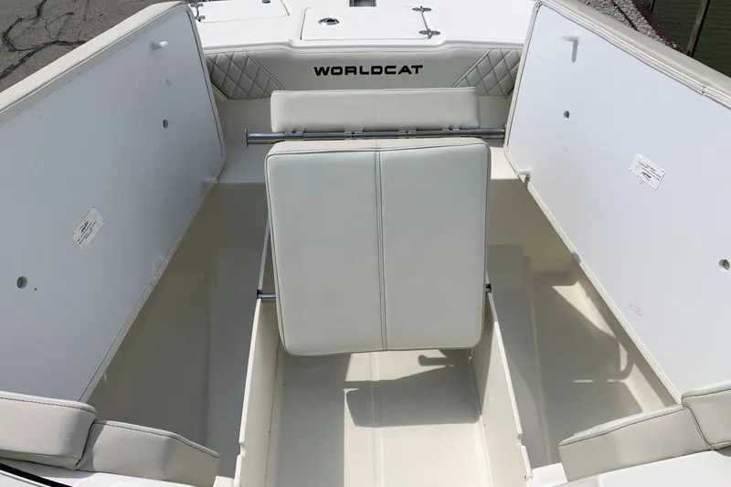 Slide: The Image of 2026 World Cat 230 SD boat interior with white seating and storage compartments. - 9