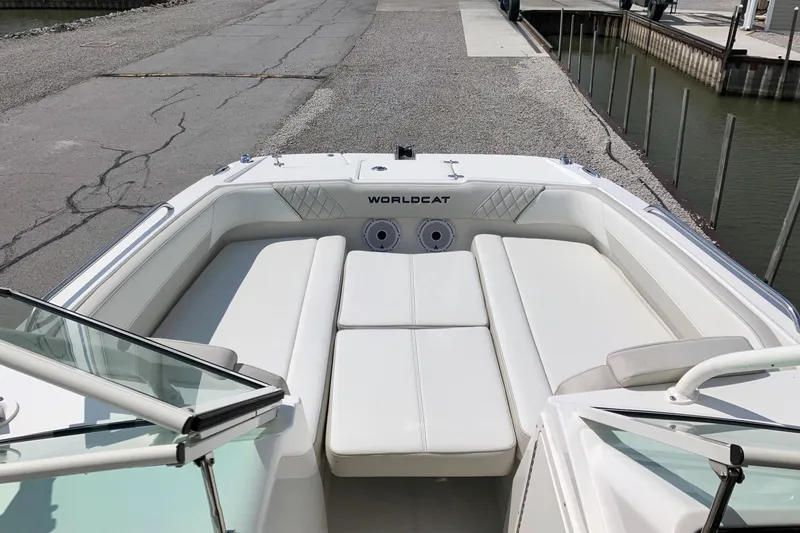 Slide: The Image of 2026 World Cat 230 SD boat interior with white seating at dock. - 8