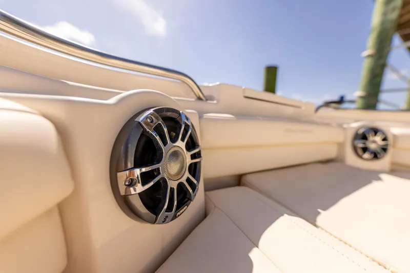 Slide: The Image of 2022 Grady-White Canyon 336 boat interior with premium speakers and luxurious seating. - 13