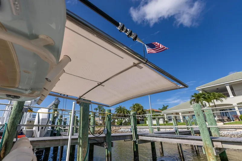 Slide: The Image of 2022 Grady-White Canyon 336 boat docked, American flag waving, sunny day. - 18