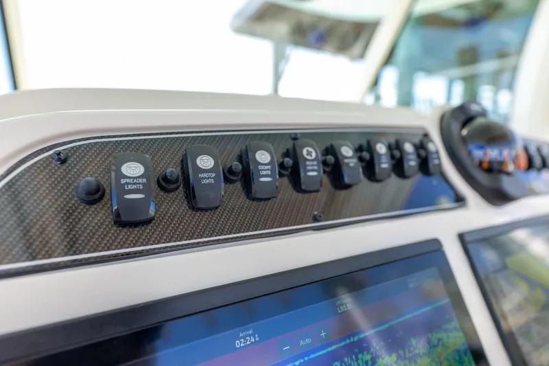 Slide: The Image of Control panel of 2022 Grady-White Canyon 336 boat with labeled switches and display. - 20