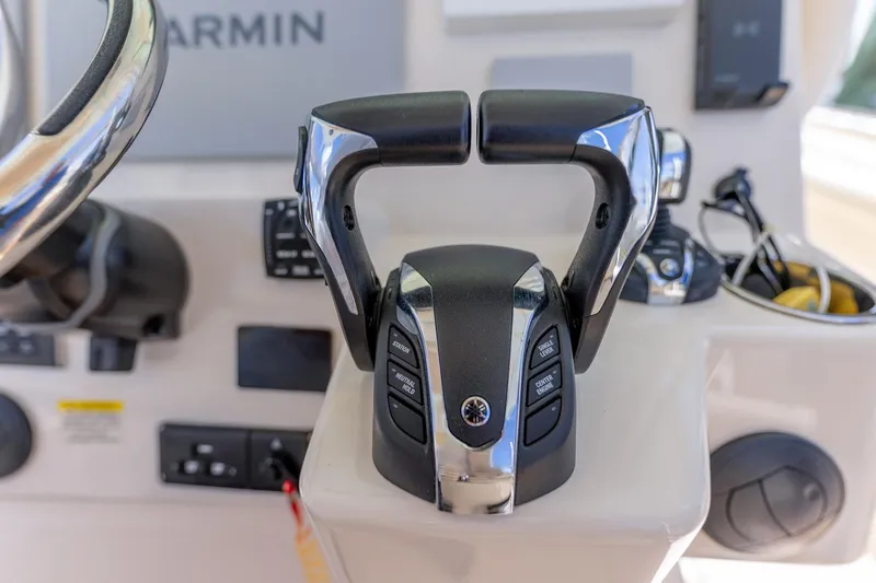 Slide: The Image of Control panel of 2022 Grady-White Canyon 336 boat with throttle and steering wheel. - 24