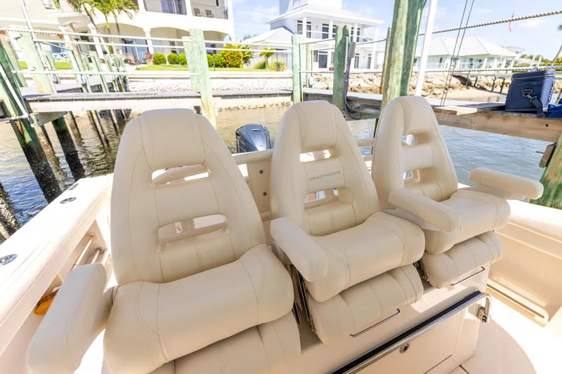 Slide: The Image of Luxury seating on 2022 Grady-White Canyon 336 boat, docked by waterfront homes. - 26
