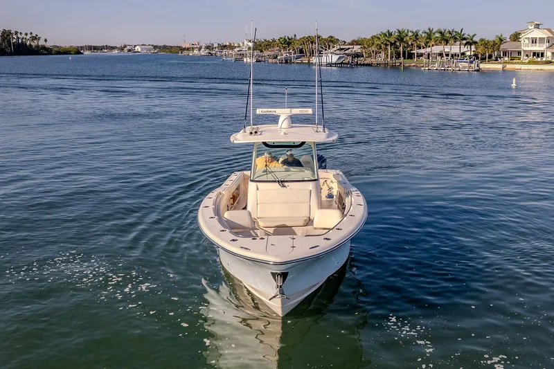 Slide: The Image of 2022 Grady-White Canyon 336 boat cruising on a calm waterway. - 3