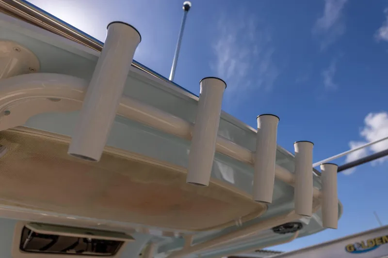 Slide: The Image of Rod holders on a 2022 Grady-White Canyon 336 boat under a clear blue sky. - 30