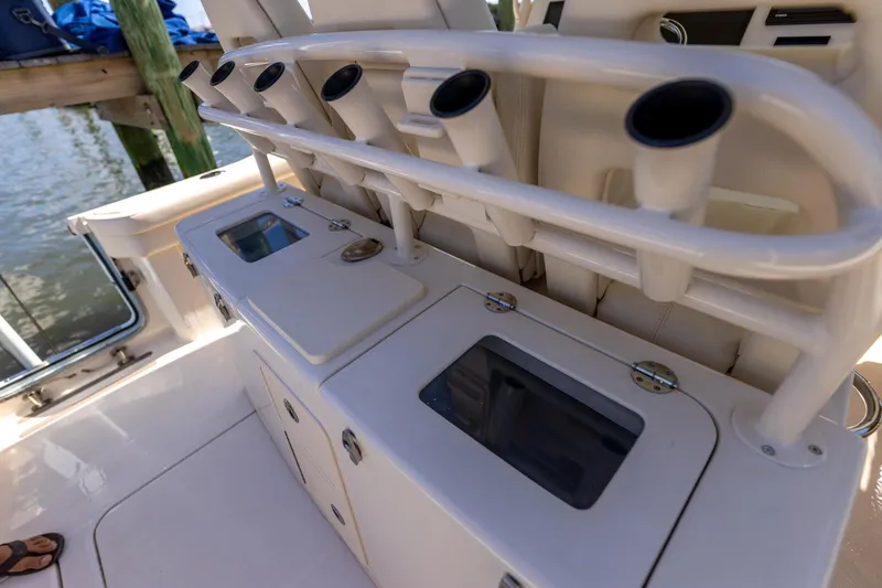 Slide: The Image of 2022 Grady-White Canyon 336 boat interior with rod holders and storage compartments. - 31