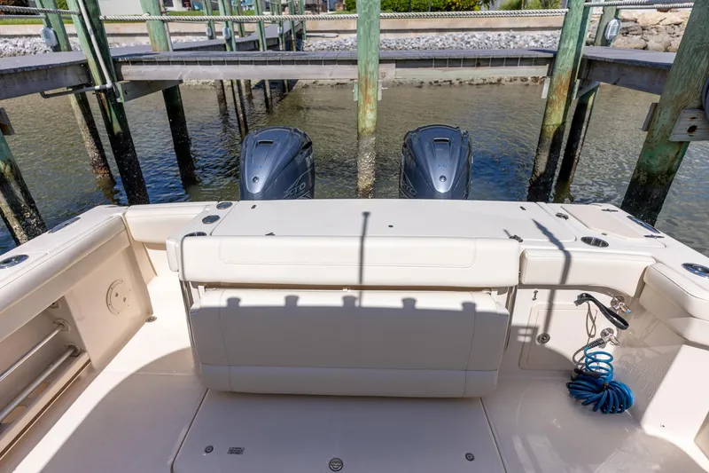 Slide: The Image of 2022 Grady-White Canyon 336 boat stern view with twin outboard engines. - 34