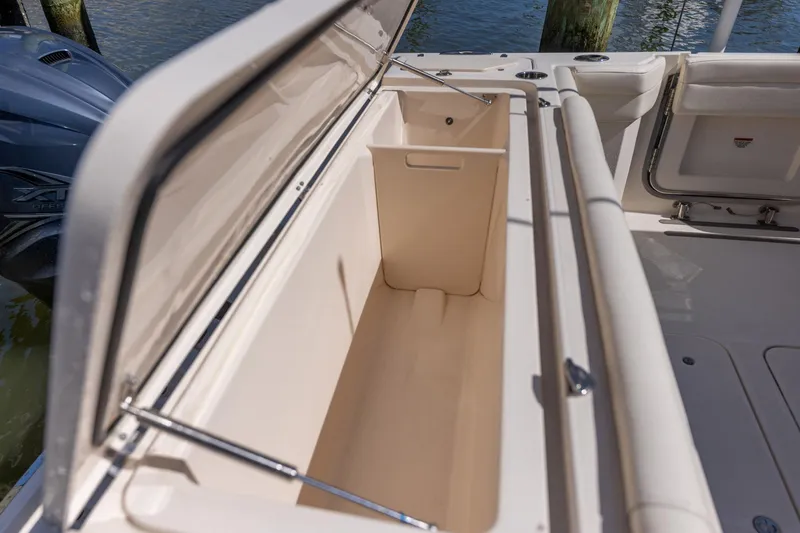 Slide: The Image of 2022 Grady-White Canyon 336 boat storage compartment open, showcasing spacious interior. - 37