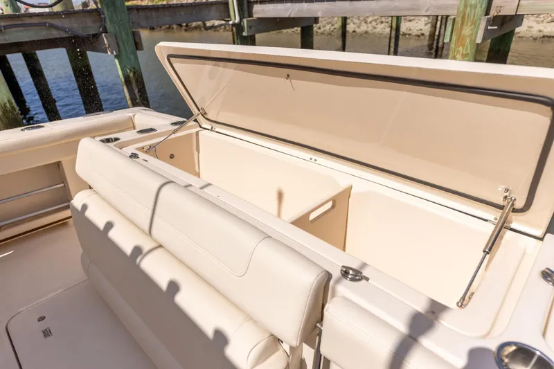 Slide: The Image of 2022 Grady-White Canyon 336 boat with open storage compartment, dockside view. - 38