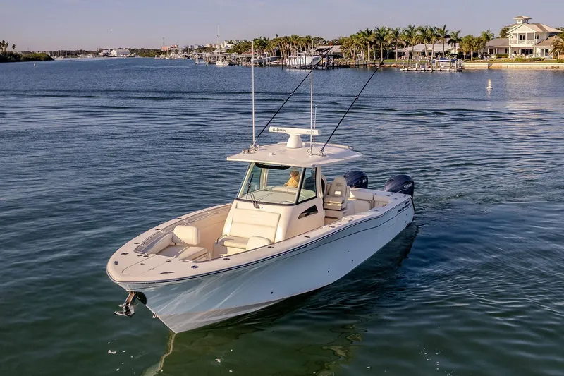 Slide: The Image of 2022 Grady-White Canyon 336 boat cruising on a serene waterway. - 4