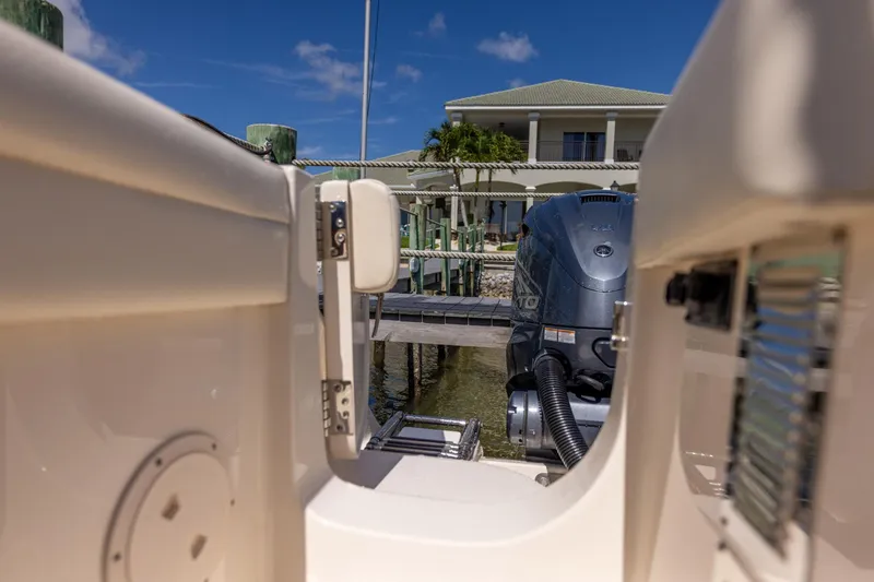 Slide: The Image of 2022 Grady-White Canyon 336 boat with outboard motor at dock, sunny day. - 40