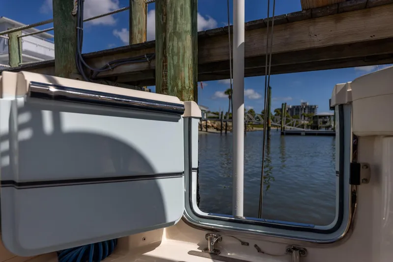 Slide: The Image of 2022 Grady-White Canyon 336 boat docked by a scenic waterfront. - 42