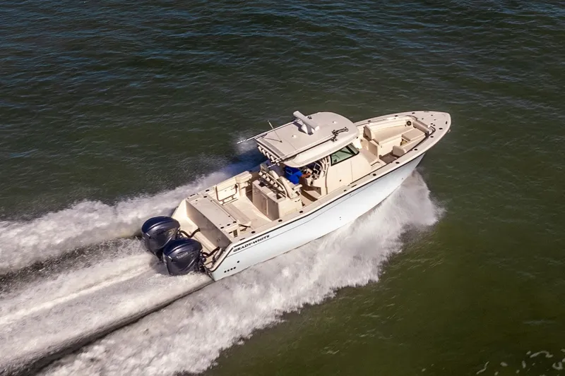 Slide: The Image of 2022 Grady-White Canyon 336 boat cruising on open water, aerial view. - 49