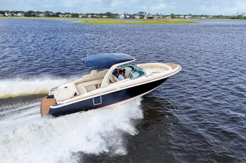 The Image of 2020 Chris-Craft Launch 31 GT speedboat cruising on a lake, showcasing luxury and performance. - 0