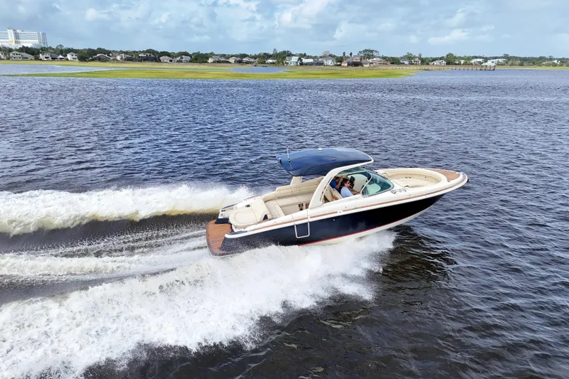 Slide: The Image of 2020 Chris-Craft Launch 31 GT cruising on open water, showcasing sleek design and performance. - 13