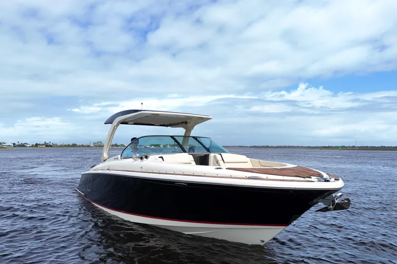 Slide: The Image of 2020 Chris-Craft Launch 31 GT boat on open water under a cloudy sky. - 18