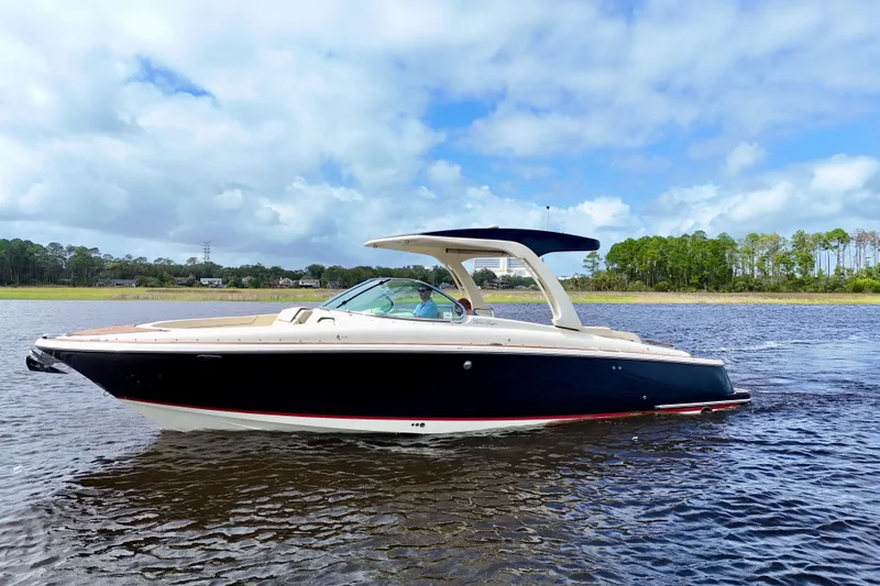 Slide: The Image of 2020 Chris-Craft Launch 31 GT boat on calm water under a blue sky. - 19