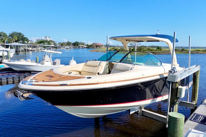 Slide: The Image of 2020 Chris-Craft Launch 31 GT boat docked on a sunny day by the water. - 25