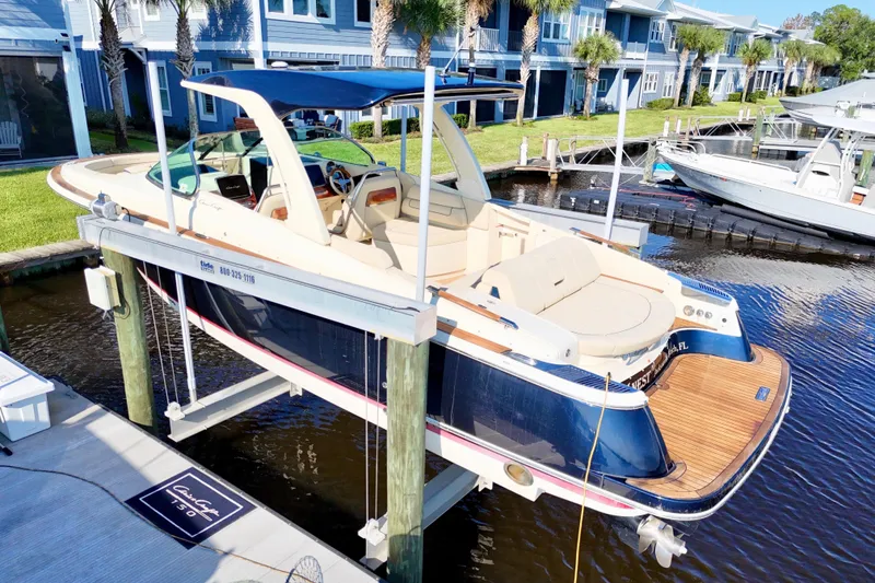 Slide: The Image of 2020 Chris-Craft Launch 31 GT boat docked, showcasing elegant design and luxury features. - 26