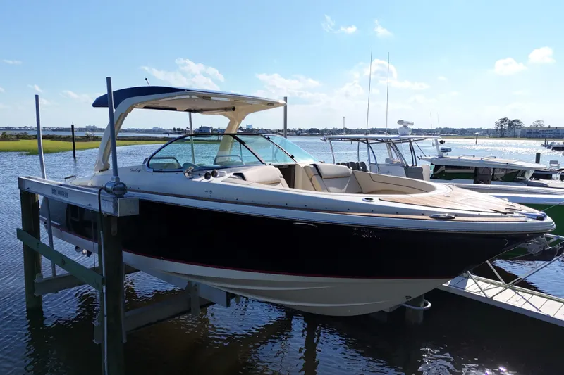 Slide: The Image of 2020 Chris-Craft Launch 31 GT boat docked on a sunny day. - 28