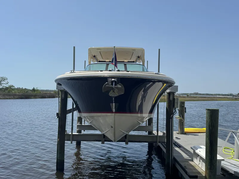 Slide: The Image of 2020 Chris-Craft Launch 31 GT boat docked on lift, front view. - 34