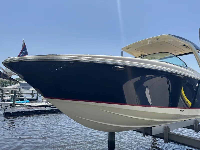 Slide: The Image of 2020 Chris-Craft Launch 31 GT boat docked, showcasing sleek design and elegant navy hull. - 35