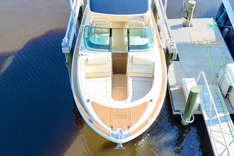 Slide: The Image of 2020 Chris-Craft Launch 31 GT boat docked, aerial view showcasing elegant design and spacious seating. - 40