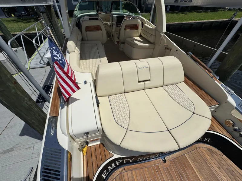 Slide: The Image of 2020 Chris-Craft Launch 31 GT boat interior with American flag, luxury seating, and wooden deck. - 61