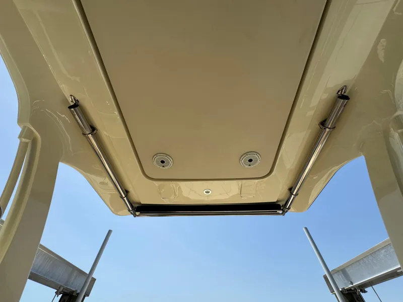 Slide: The Image of 2020 Chris-Craft Launch 31 GT boat roof with hydraulic supports against clear sky. - 66