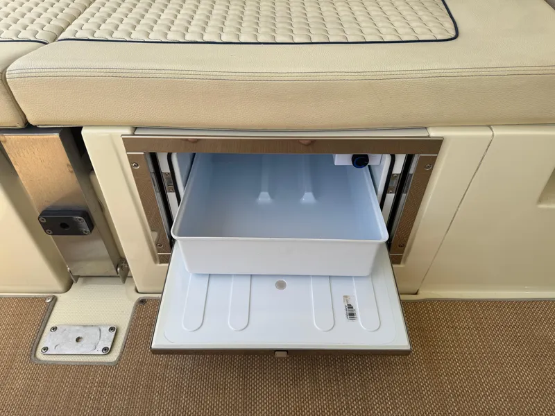 Slide: The Image of Open storage compartment on 2020 Chris-Craft Launch 31 GT boat with beige seating. - 71