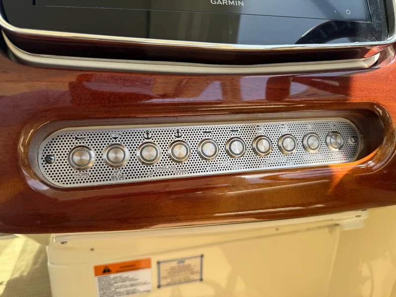 Slide: The Image of Dashboard controls of 2020 Chris-Craft Launch 31 GT boat with wood finish. - 73
